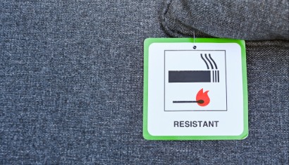 Label on the cushion of furniture showing the fabric has been treated to make it fire resistant