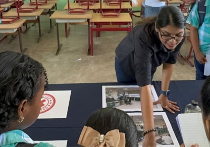 An Intertek employee talks to school children. 