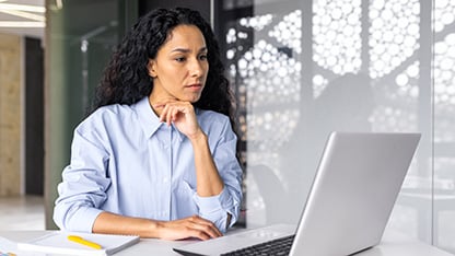 person engaged, viewing laptop