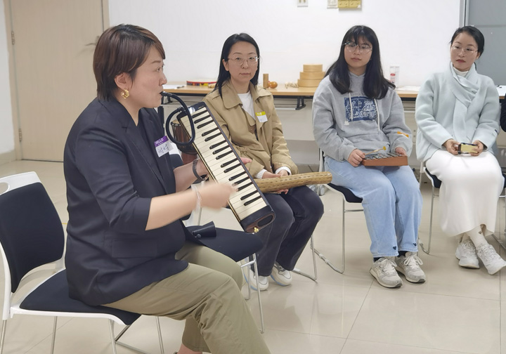 A group of women in a music workshop. 