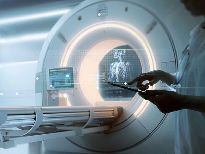 Doctor in white lab coat using digital tablet for advanced Mri x-ray scan of medical diagnosis machine at hospital