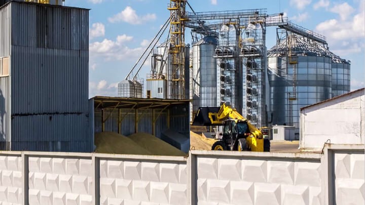 Heavy work equipment near stockpile