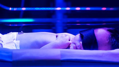 A baby peacefully resting while receiving phototherapy for jaundice at the hospital