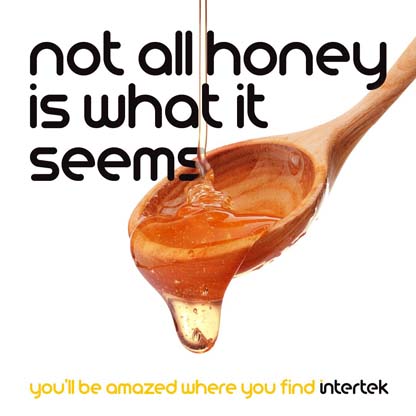 A wooden spoon filled with honey