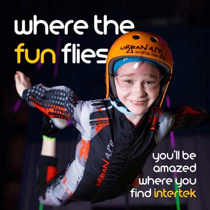 A child wearing an indoor skydiving suit