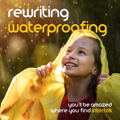 A young girll smiling from beneath a rain coat in the rain