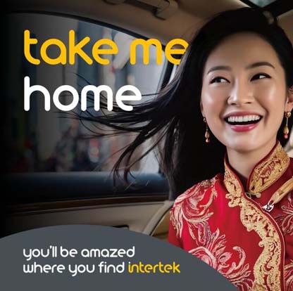 A smiling woman wearing a traditional Asian dress riding in a car