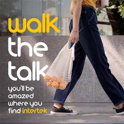 A woman walking with a reusable grocery bag