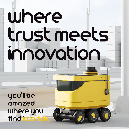 A wheeled robot in front of a modern cityscape
